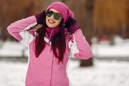 Woman in winter sports clothes looking at cameraの写真素材
