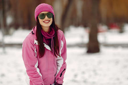 Woman in winter sports clothes looking at cameraの写真素材
