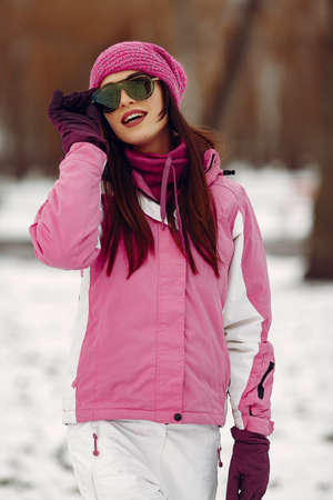 Woman in winter sports clothes looking at cameraの写真素材