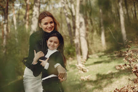 Elegant mother with daughter in a summer forestの写真素材