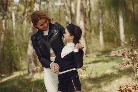 Elegant mother with daughter in a summer forestの写真素材