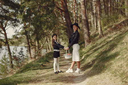 Elegant mother with daughter in a summer forestの写真素材