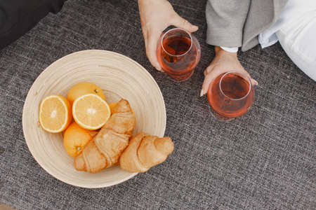 People sitting by the water with picnic set