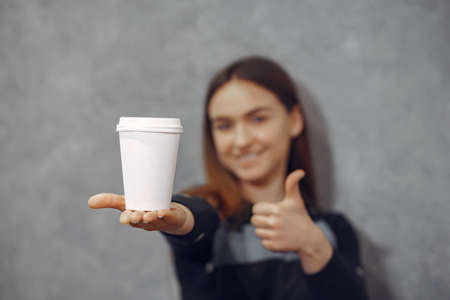 Young barista girl makes coffee and smilesの写真素材