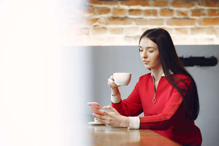 Woman drinking coffee in the morning at restaurantの写真素材