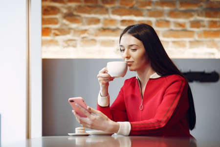 Woman drinking coffee in the morning at restaurantの写真素材