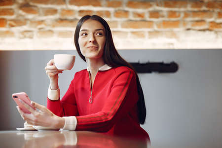 Woman drinking coffee in the morning at restaurantの写真素材