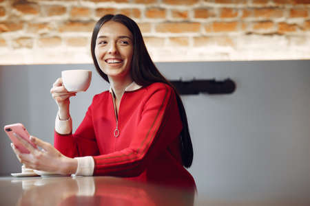 Woman drinking coffee in the morning at restaurantの写真素材