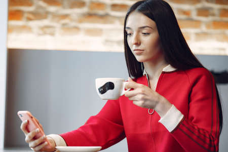 Woman drinking coffee in the morning at restaurantの写真素材
