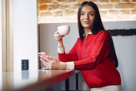 Woman drinking coffee in the morning at restaurantの写真素材