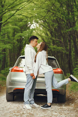 Beautiful couple spend time in a spring forestの写真素材