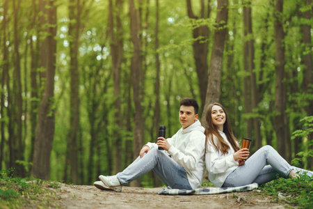 Beautiful couple spend time in a spring forestの写真素材