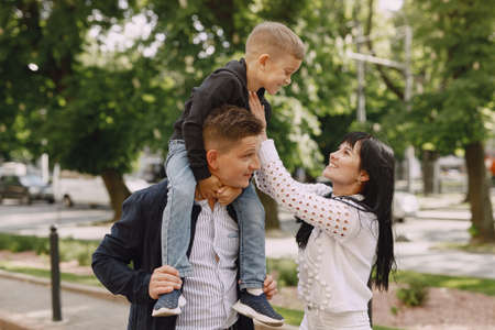 Cute family playing in a summer parkの写真素材