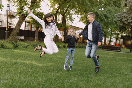 Cute family playing in a summer parkの写真素材