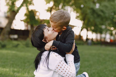 Mother with son playing in a summer parkの写真素材