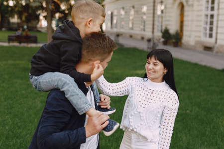 Cute family playing in a summer parkの写真素材