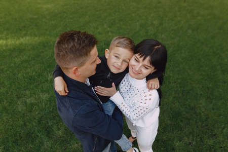 Cute family playing in a summer parkの写真素材