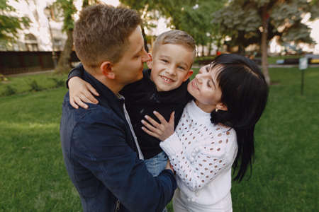 Cute family playing in a summer parkの写真素材