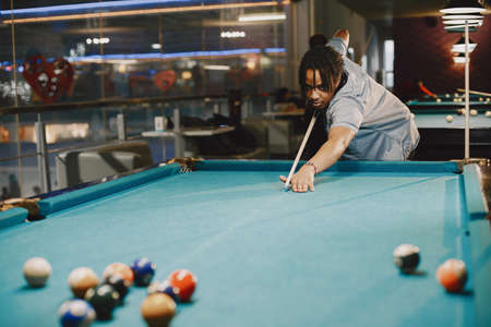 Man playing billiards in a clubの写真素材