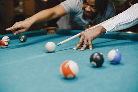 Game of billiards. Men with a cane. Men's gamesの写真素材
