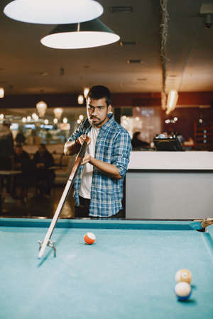 Man playing billiards in a clubの写真素材