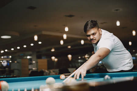 Man playing billiards in a club