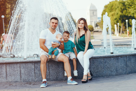 Cute family playing in a summer cityの写真素材