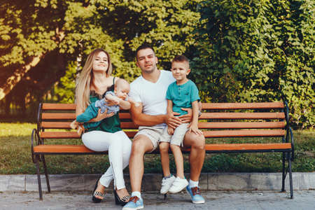 Cute family playing in a summer parkの写真素材