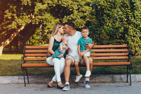 Cute family playing in a summer parkの写真素材