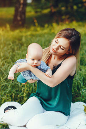 Mother with little son playing in a summer parkの写真素材