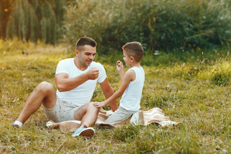 Cute family playing in a summer fieldの写真素材