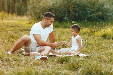 Cute family playing in a summer fieldの写真素材