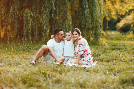 Cute family playing in a summer parkの写真素材
