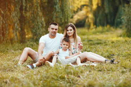 Cute family playing in a summer parkの写真素材