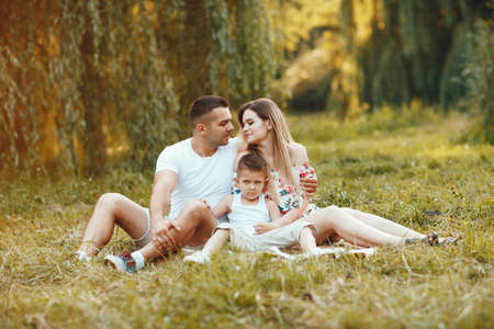 Cute family playing in a summer parkの写真素材