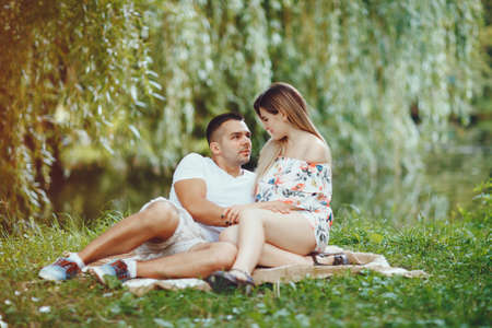Beautiful couple spend time on a summer fieldの写真素材