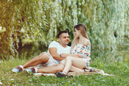 Beautiful couple spend time on a summer fieldの写真素材