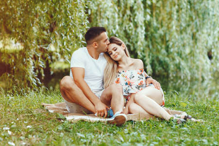 Beautiful couple spend time on a summer fieldの写真素材