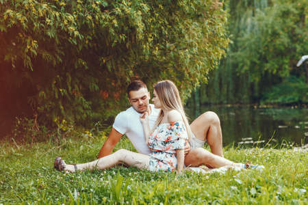Beautiful couple spend time on a summer fieldの写真素材