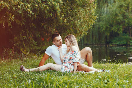 Beautiful couple spend time on a summer fieldの写真素材
