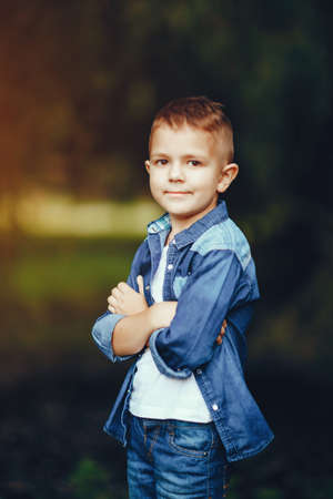 Cute little boy spend time in a summer parkの写真素材