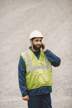 Civil engineer working outside with helmetの写真素材
