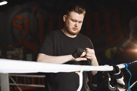 Man in a black t-shirtg boxing in a gymの写真素材