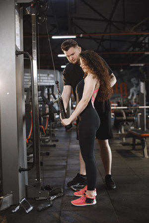 Woman is engaged in a gym with coachの写真素材