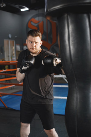 Man in a black t-shirtg boxing in a gymの写真素材