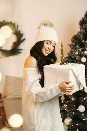 Beautiful girl at home near christmas treeの写真素材