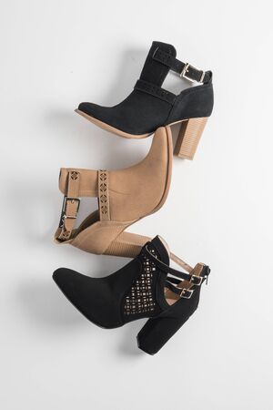 Women's footwear. Black and beige boots on white background. Aerial shotの写真素材