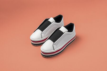 Stylish women's sneakers on color background, top viewの写真素材