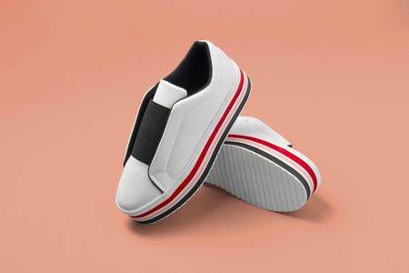 Stylish women's sneakers on color background, top viewの写真素材