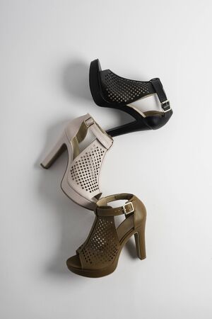 High heel lady's boot in pink, black and brown on white background.の写真素材